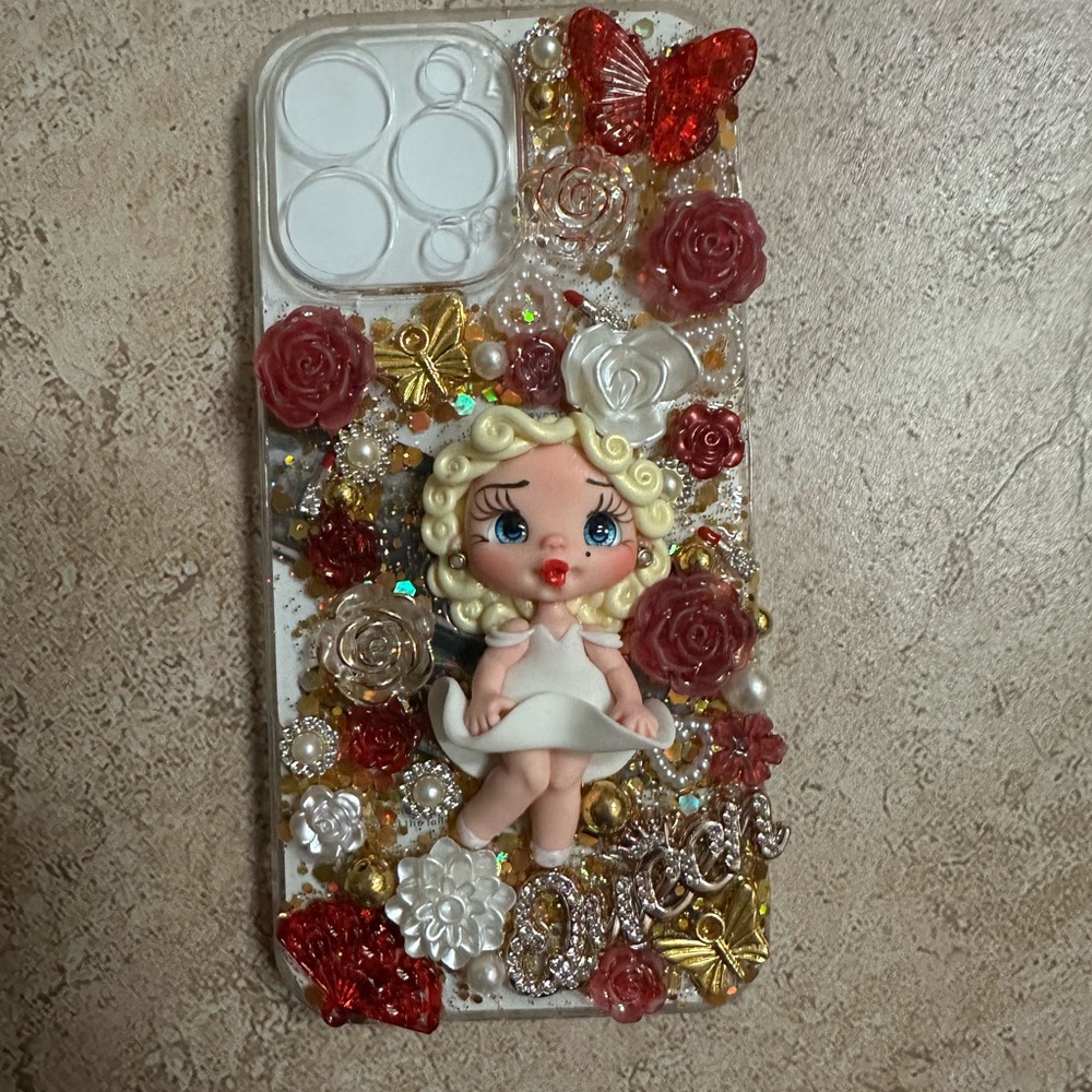 Custom Decorative Doll Phone Case with Red and Gold Accents iPhone 14 Pro Max